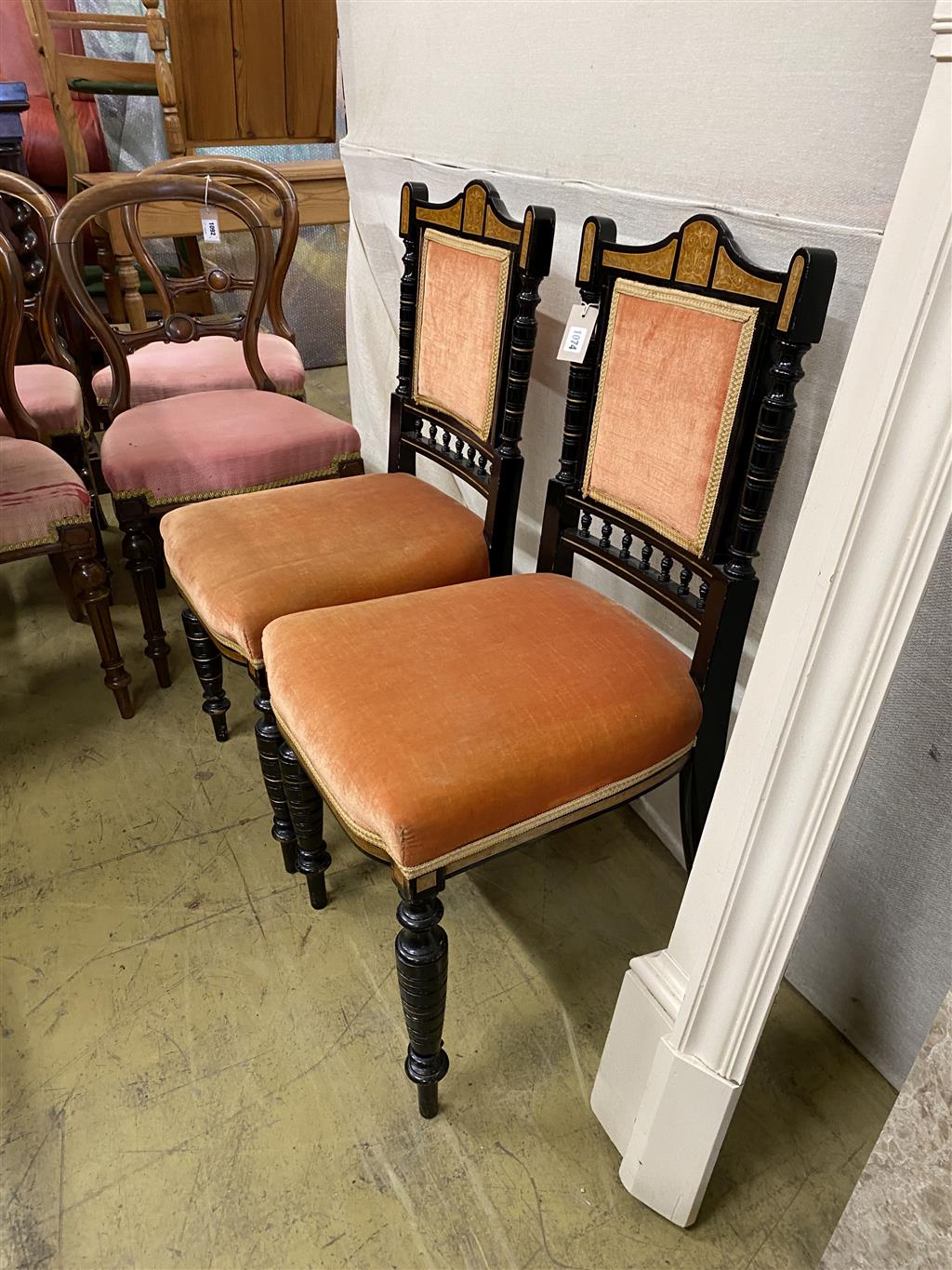 A pair of late Victorian marquetry inlaid ebonised side chairs